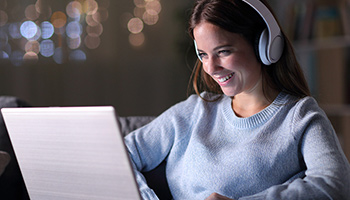 Young woman listening to laptop